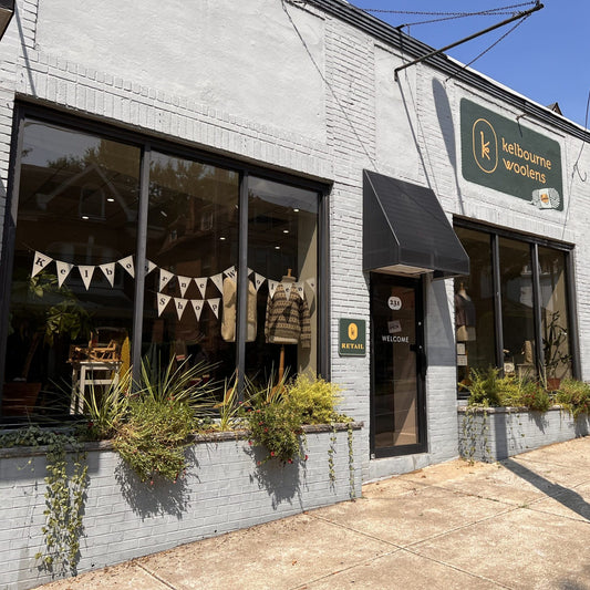 the exterior storefront of kelbourne woolens yarn shop on a summer day.